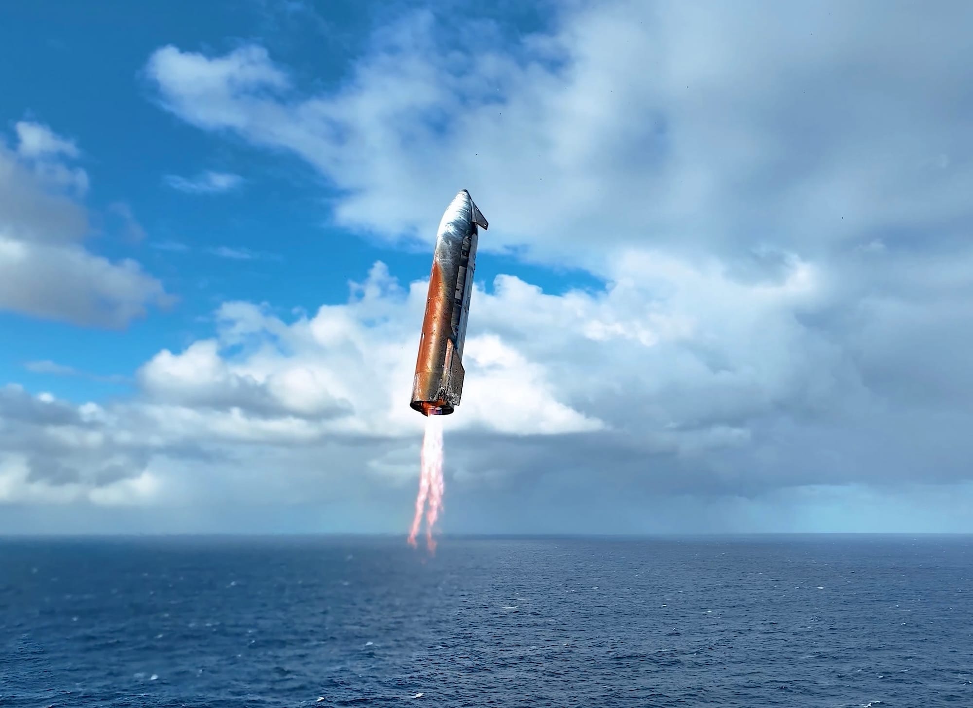 A surface-oxidized, powered Starship upper stage from SpaceX’s IFT-10 flight is seen here approaching the Indian ocean shortly before splashdown during local morning.
